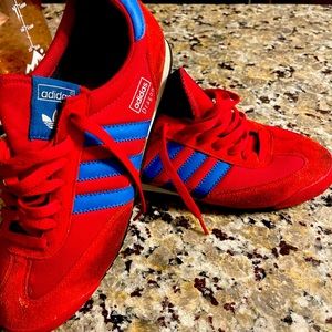 Gently worn red and blue adidas sneakers..